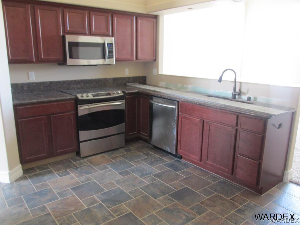 4939 North Neal Ranch Road Kingman, AZ 86401 - Photo 4 of 17 a kitchen with a sink stove and microwave