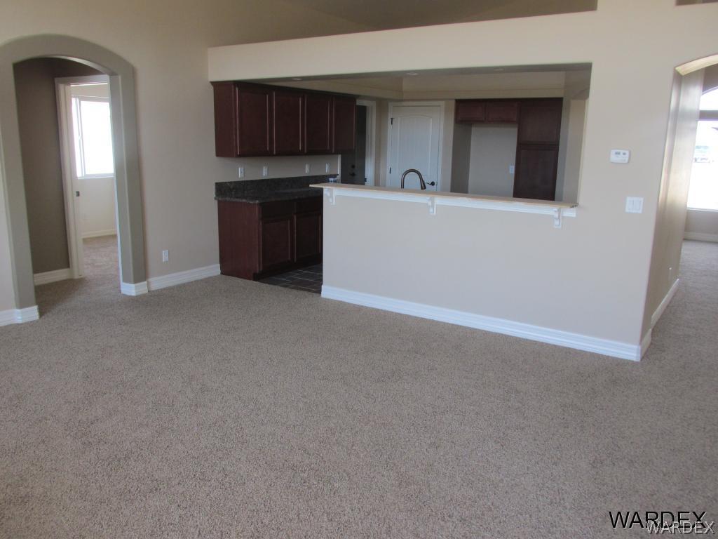 4939 North Neal Ranch Road Kingman, AZ 86401 - Photo 6 of 17 a view of a kitchen with a sink cabinets and a window