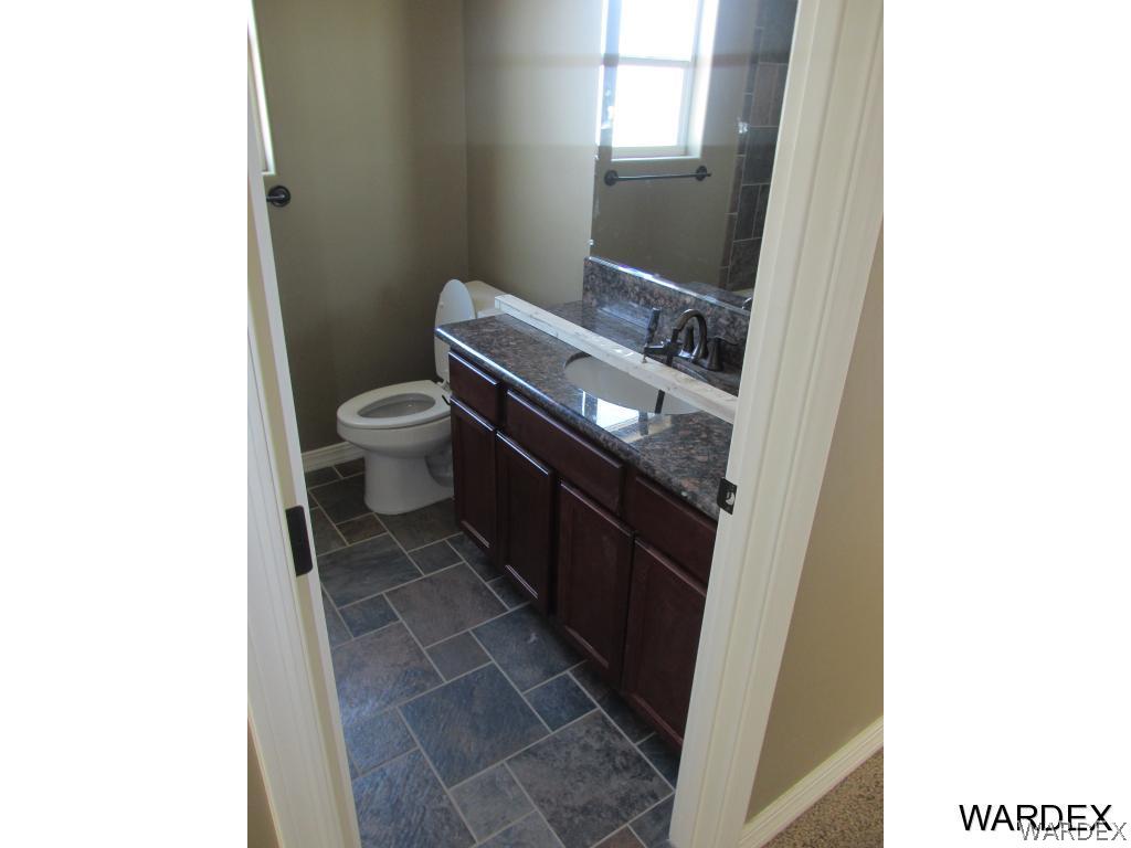 4939 North Neal Ranch Road Kingman, AZ 86401 - Photo 8 of 17 a bathroom with a toilet and a mirror