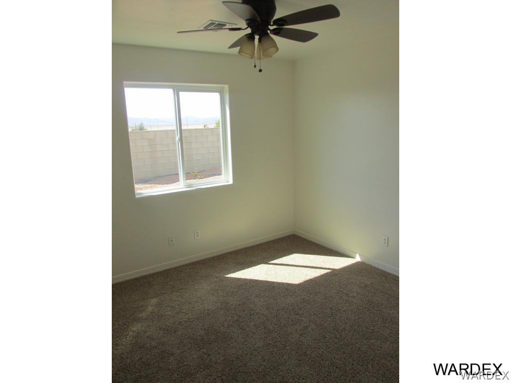4939 North Neal Ranch Road Kingman, AZ 86401 - Photo 10 of 17 a view of an empty room with a window