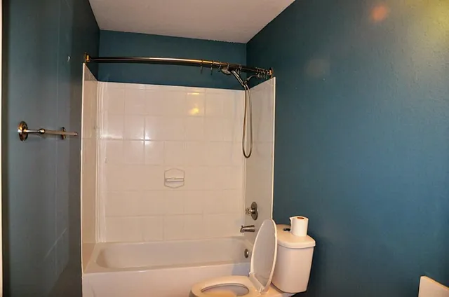 a view of wooden floor and chandelier fan in a room