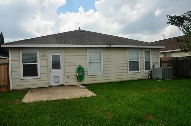 a view of a backyard with wooden fence