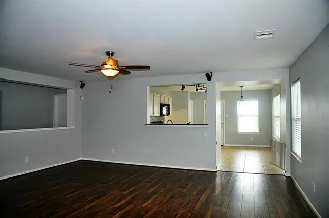 a view of wooden floor and windows in an empty room