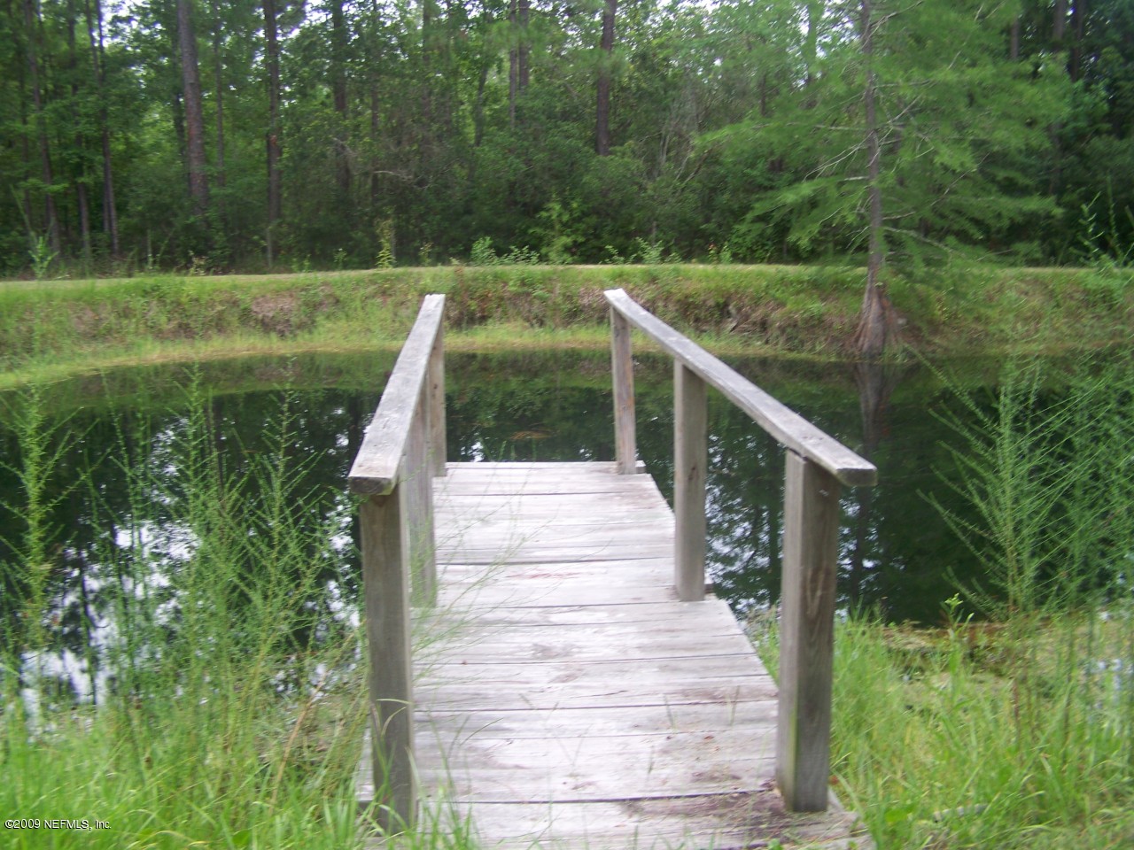 1131 Otis Road Jacksonville, FL 32220 - Photo 4 of 4 Pond with dock