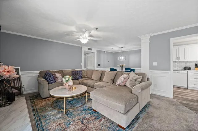 a living room with furniture and a chandelier