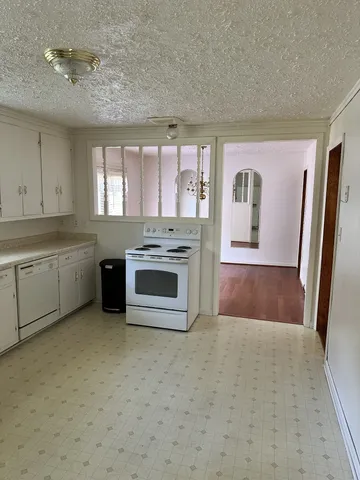 a view of a kitchen with microwave and cabinets