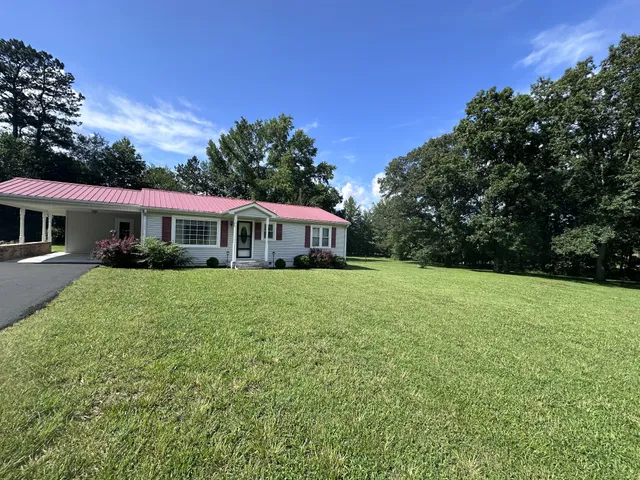 a front view of house with yard and green space