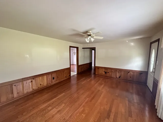 a view of an empty room with wooden floor