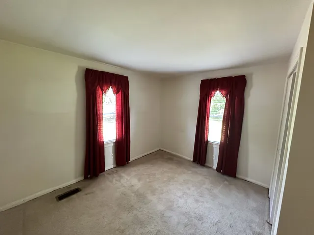 an empty room with stairs and a window