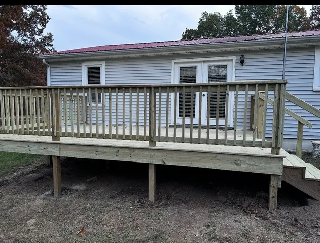 a view of a house with a small roof deck