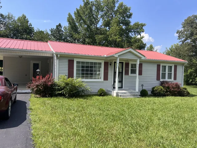 a front view of a house with a yard and porch