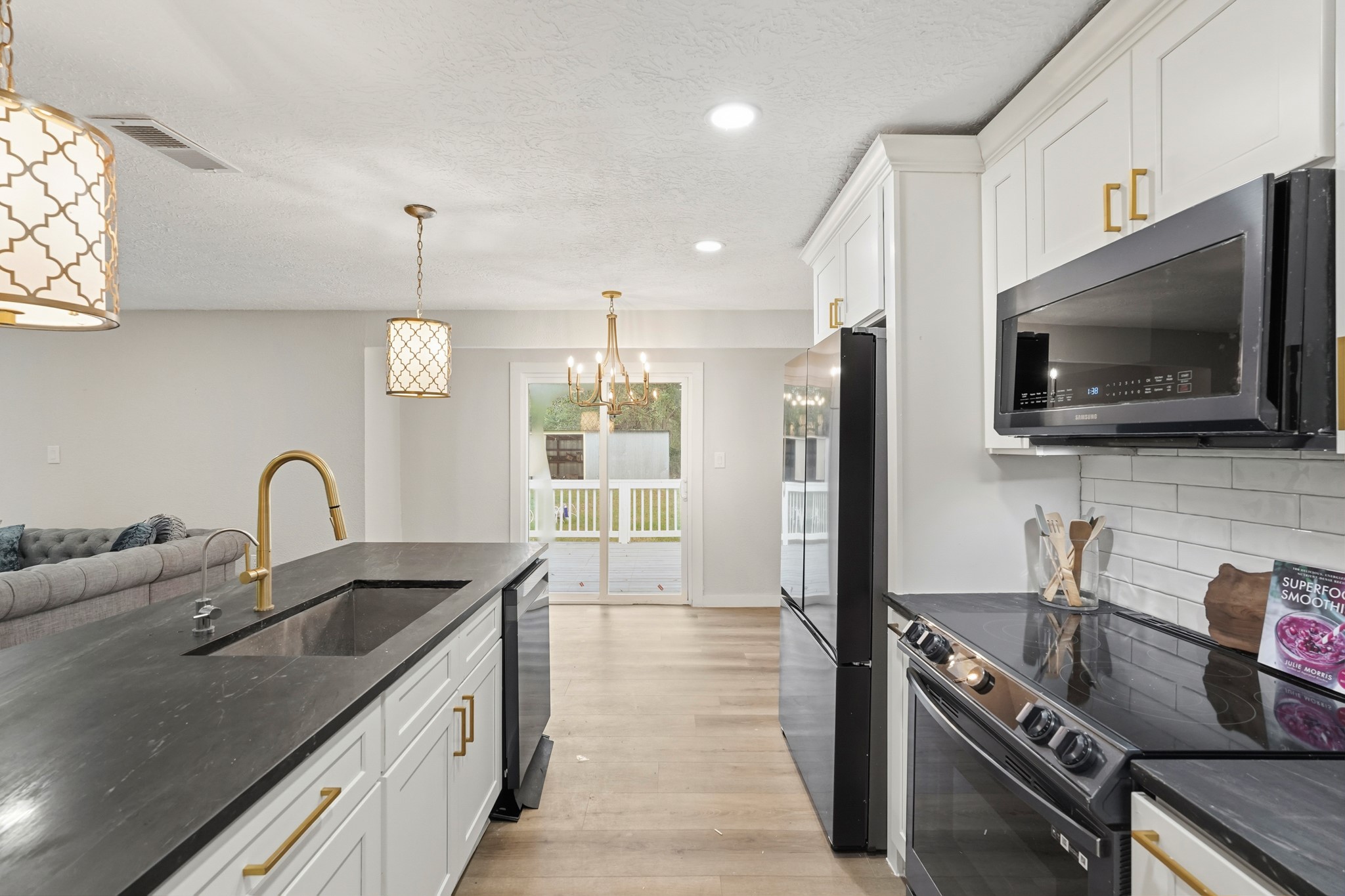 24006 Crooked Creek Road Hockley, TX 77447 - Photo 11 of 25 a kitchen with kitchen island granite countertop a sink stainless steel appliances and cabinets