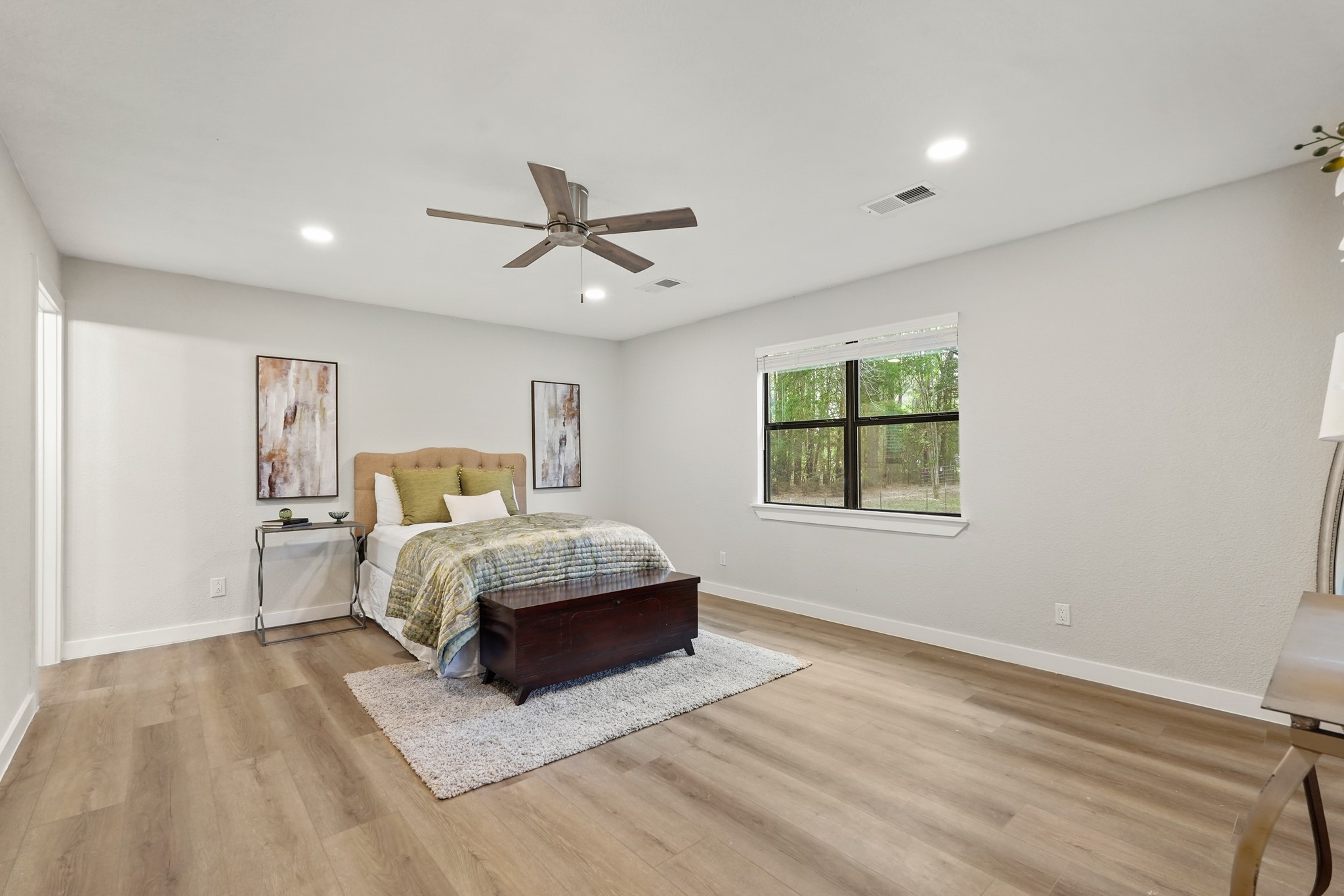 24006 Crooked Creek Road Hockley, TX 77447 - Photo 14 of 25 a spacious bedroom with a large bed and a window
