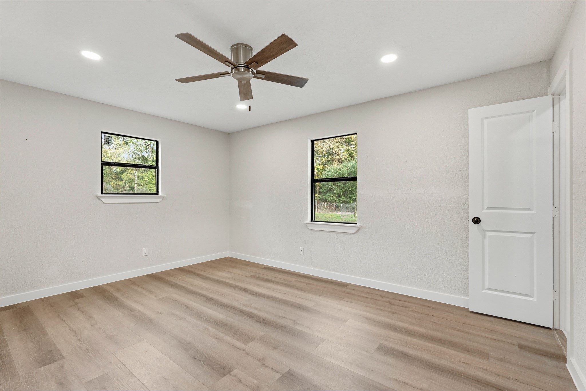 24006 Crooked Creek Road Hockley, TX 77447 - Photo 18 of 25 wooden floor in an empty room with a window