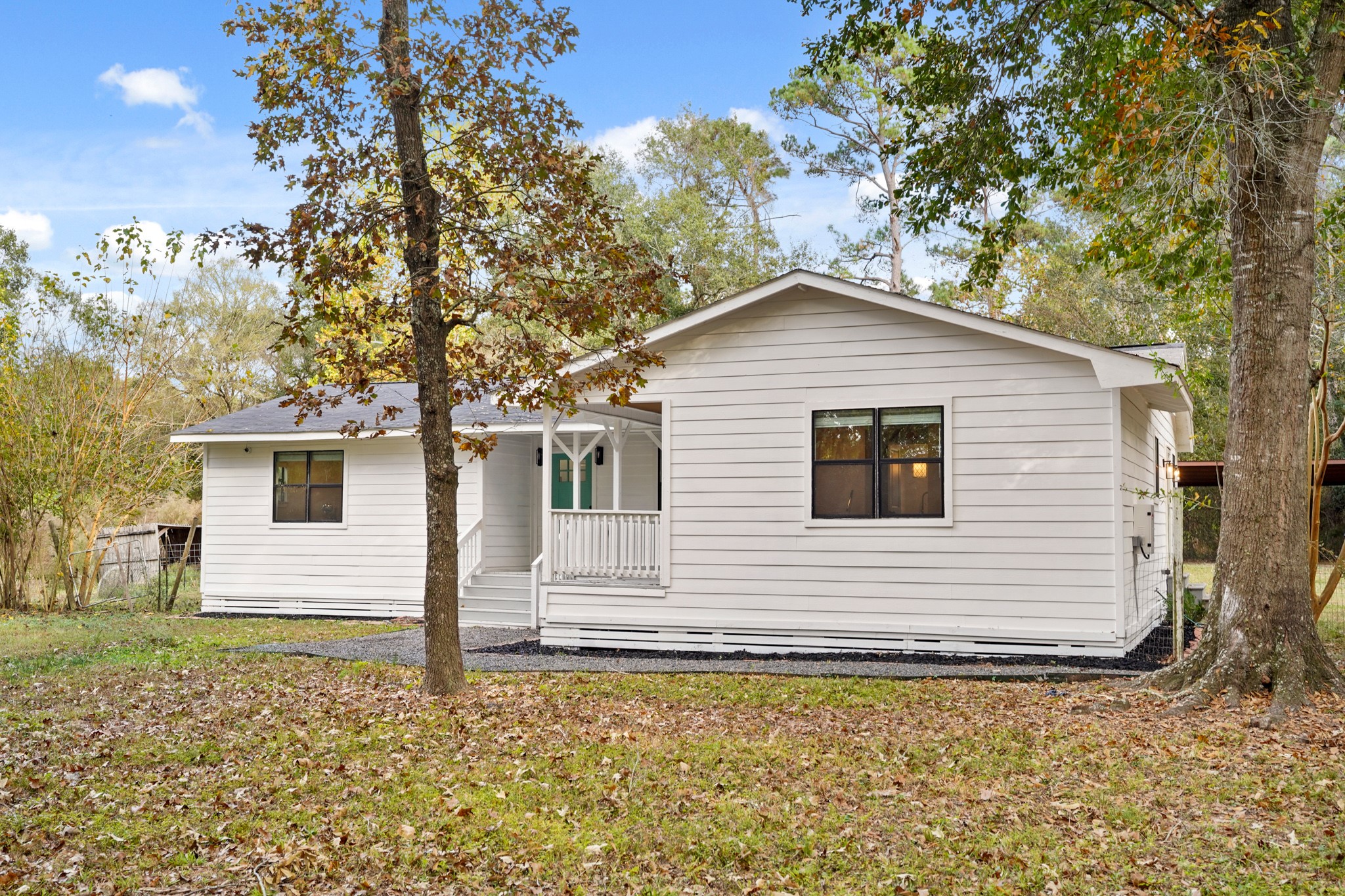 24006 Crooked Creek Road Hockley, TX 77447 - Photo 4 of 25 a white house that has a tree in front of it