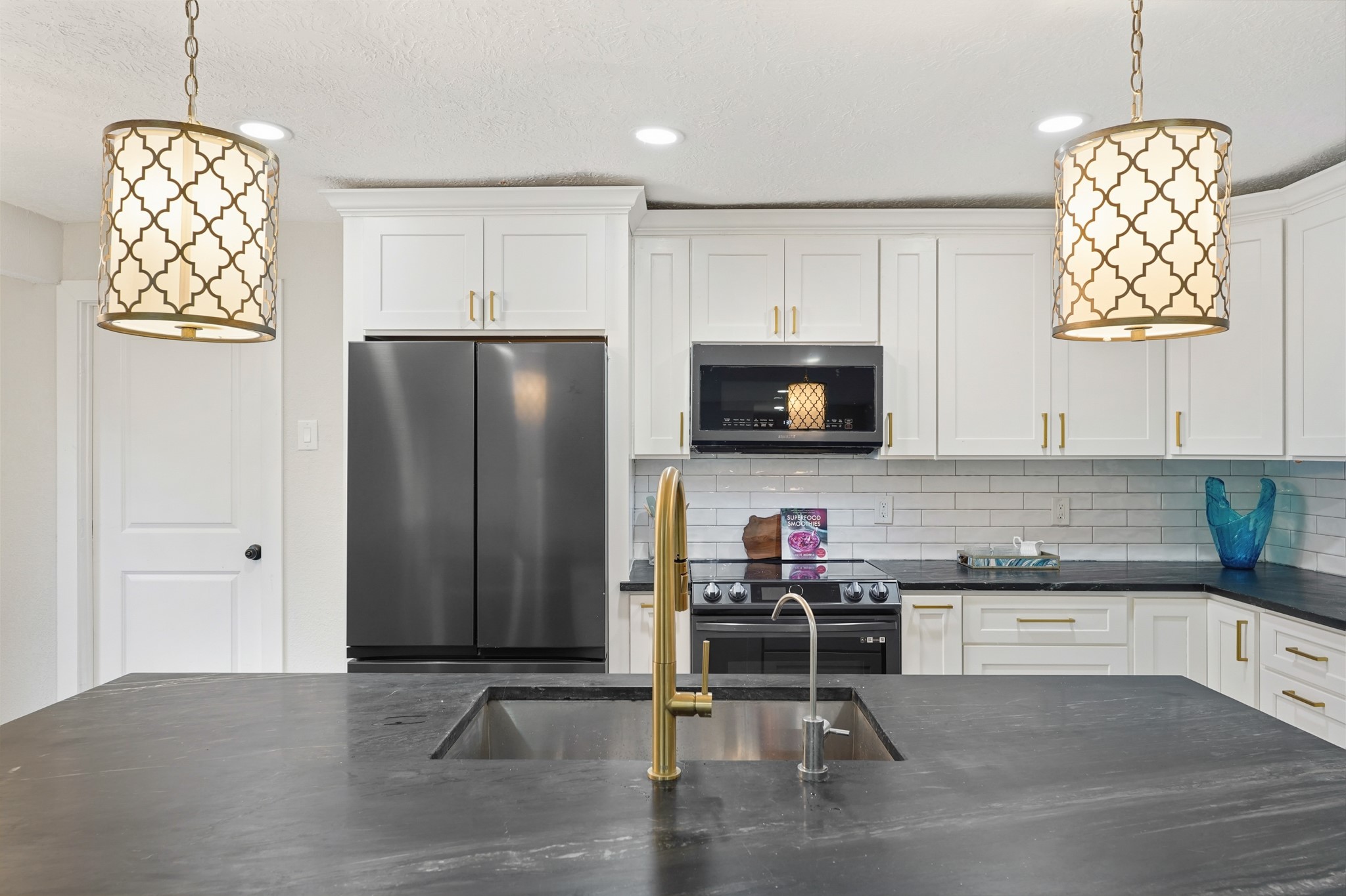 24006 Crooked Creek Road Hockley, TX 77447 - Photo 9 of 25 a kitchen with stainless steel appliances granite countertop a refrigerator stove and microwave
