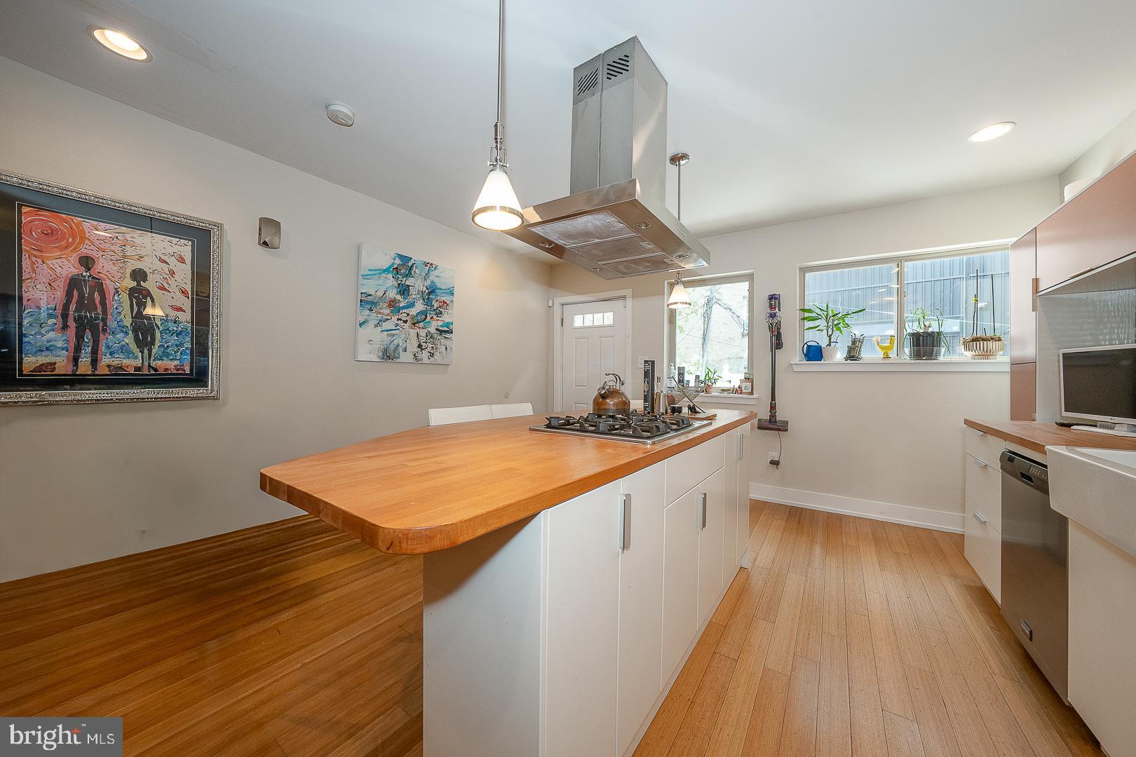 715 Shirley Street, Unit A Philadelphia, PA 19130 - Photo 10 of 24 a kitchen with stainless steel appliances granite countertop a stove a sink dishwasher and a refrigerator with wooden floor