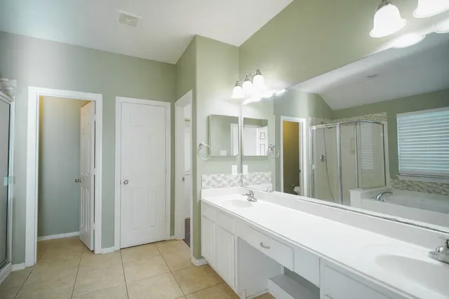 a bathroom with a double vanity sink and a mirror
