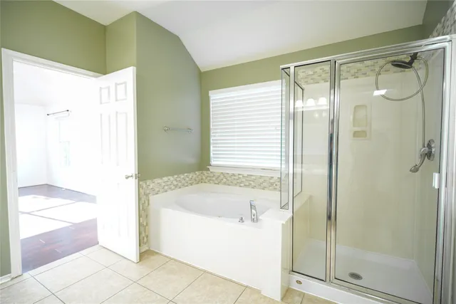 a bathroom with a bathtub and a shower