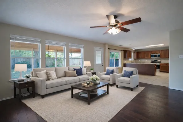 a living room with furniture and a large window