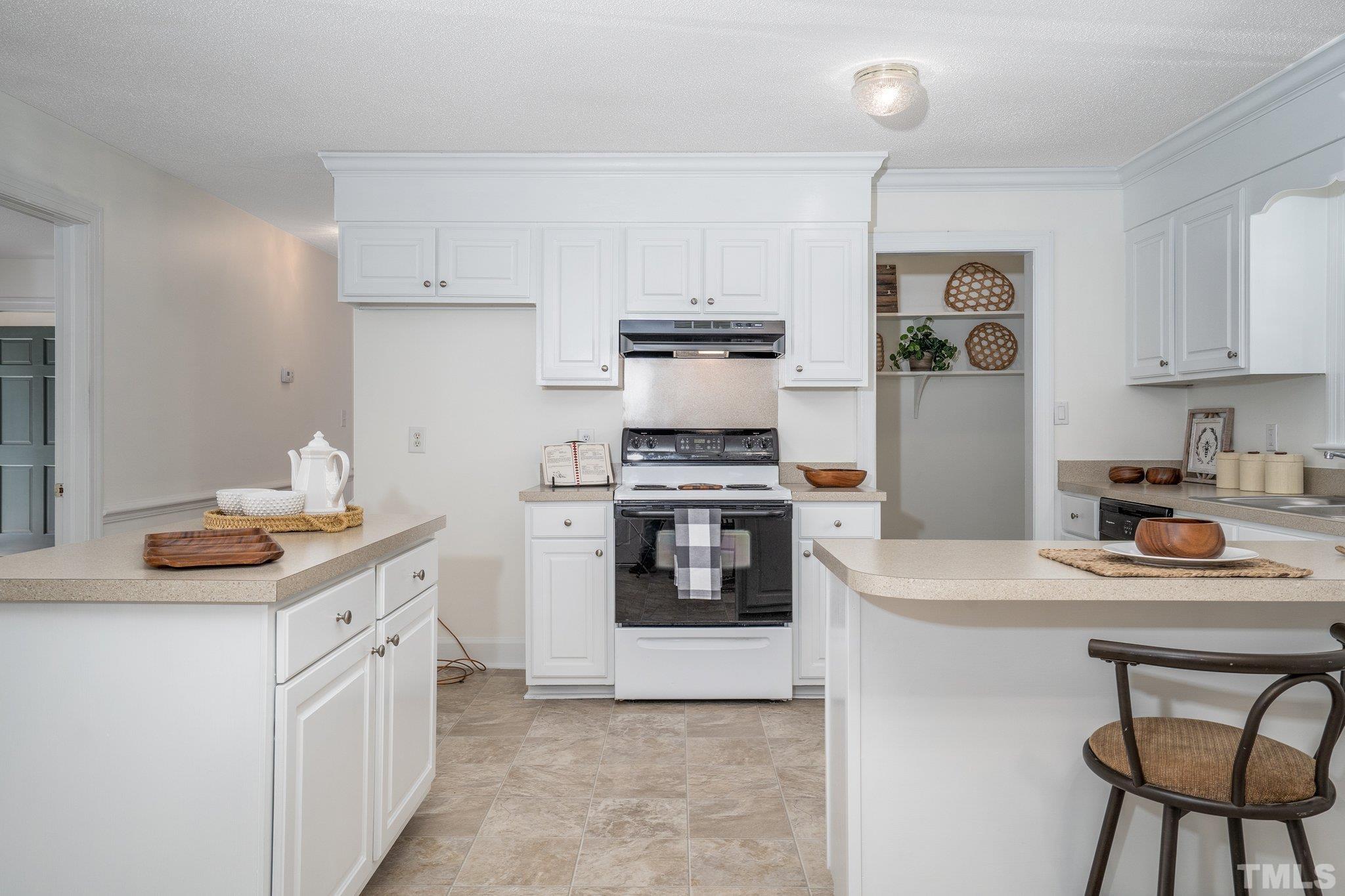1106 Raleigh Rd Parkway West Wilson, NC 27896 - Photo 13 of 22 a kitchen with stainless steel appliances a stove a sink and white cabinets