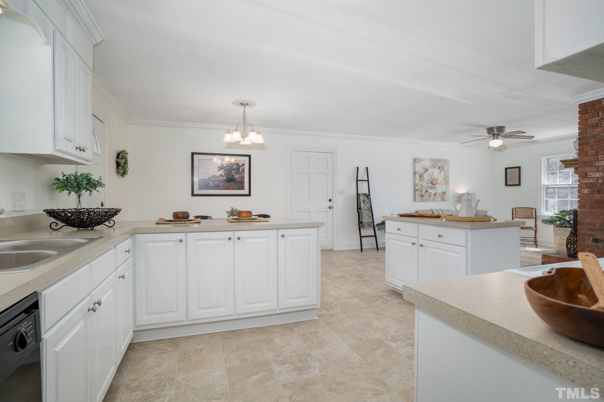 1106 Raleigh Rd Parkway West Wilson, NC 27896 - Photo 16 of 22 a kitchen with granite countertop white cabinets and white appliances