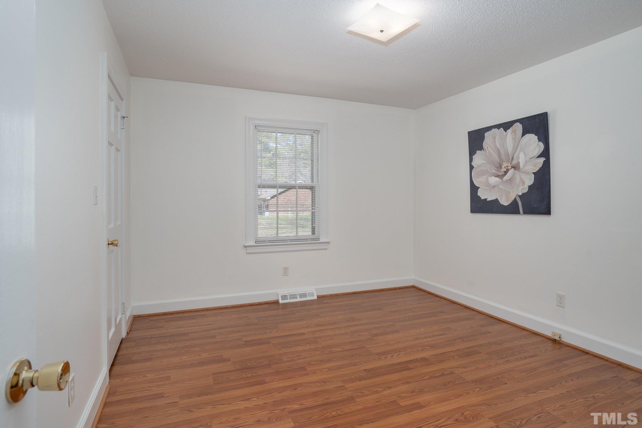 1106 Raleigh Rd Parkway West Wilson, NC 27896 - Photo 17 of 22 wooden floor in an empty room with a window