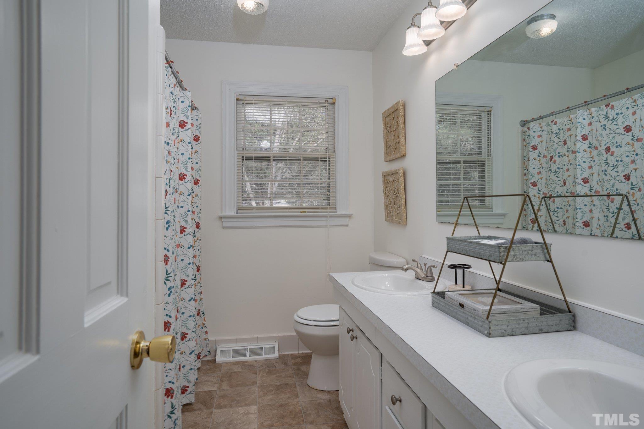 1106 Raleigh Rd Parkway West Wilson, NC 27896 - Photo 21 of 22 a bathroom with a sink a toilet and shower