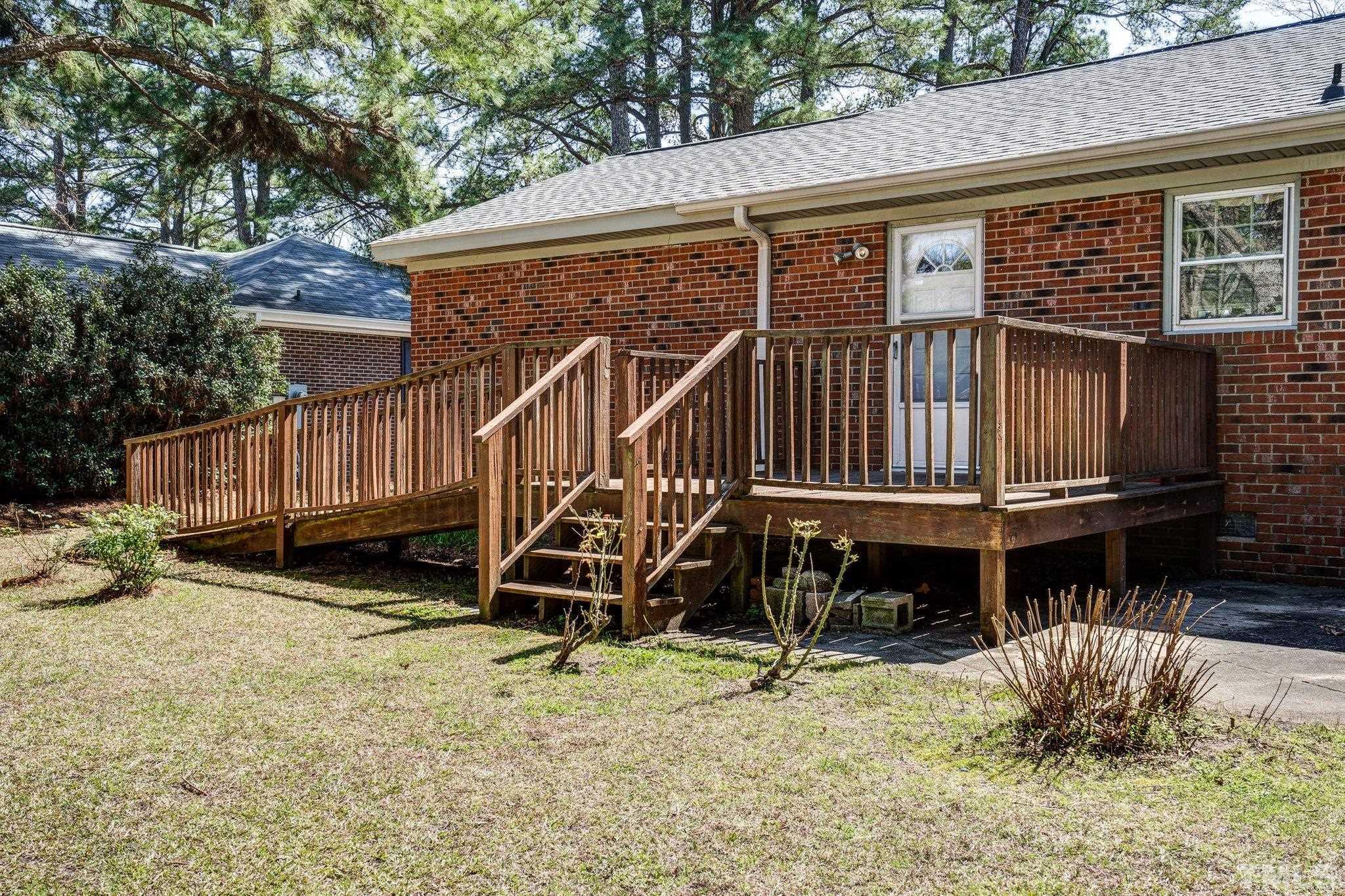 1106 Raleigh Rd Parkway West Wilson, NC 27896 - Photo 3 of 22 a house with wooden fence and deck