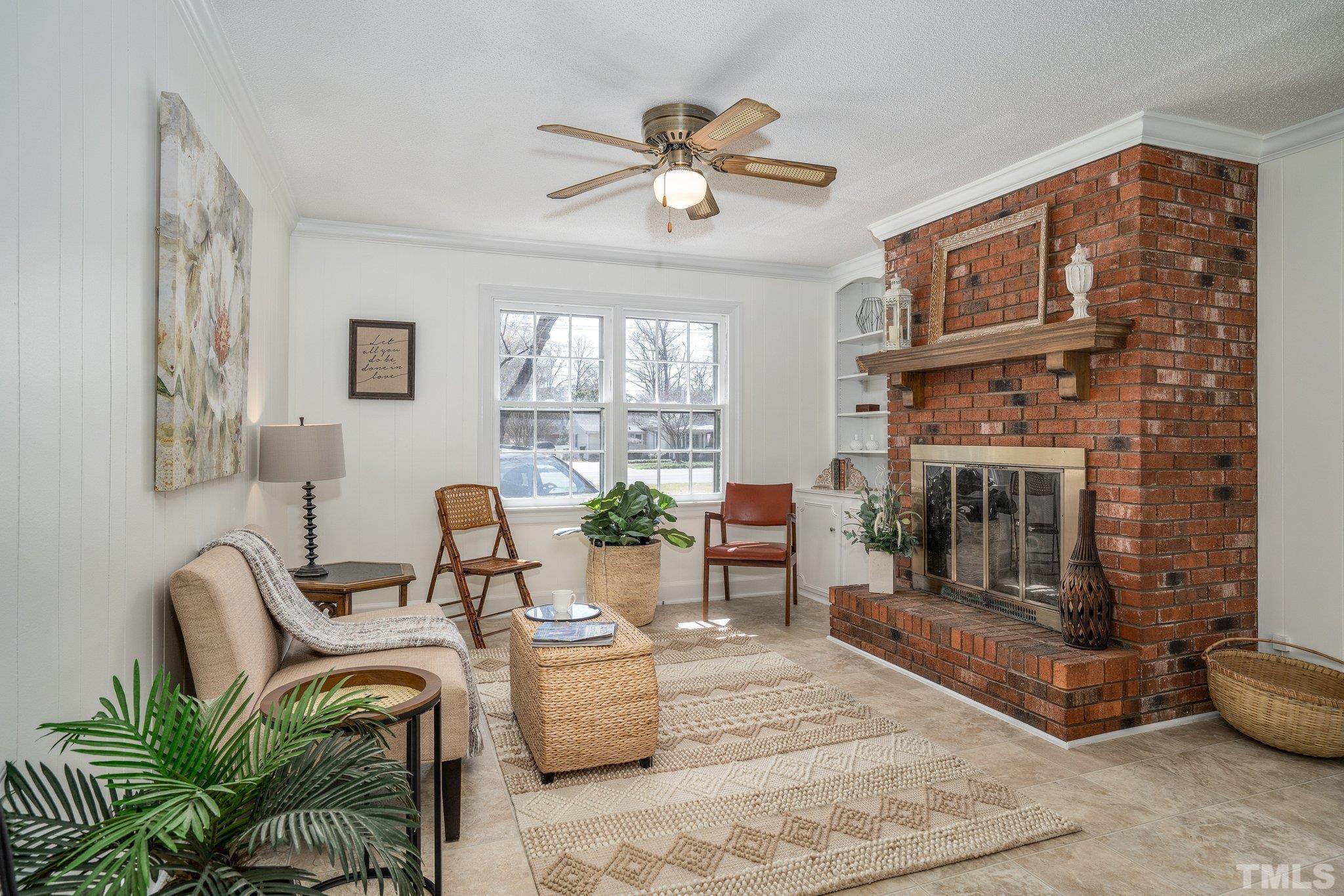 1106 Raleigh Rd Parkway West Wilson, NC 27896 - Photo 7 of 22 a living room with furniture a fireplace and a chandelier
