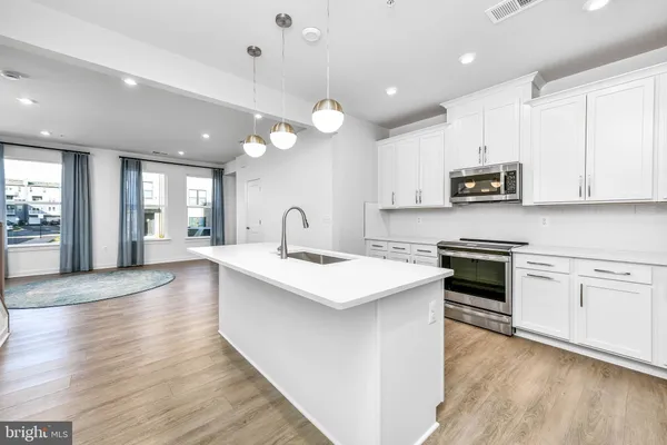 a kitchen with a stove and a sink