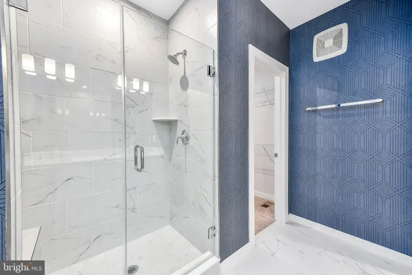 a bathroom with a shower and a sink