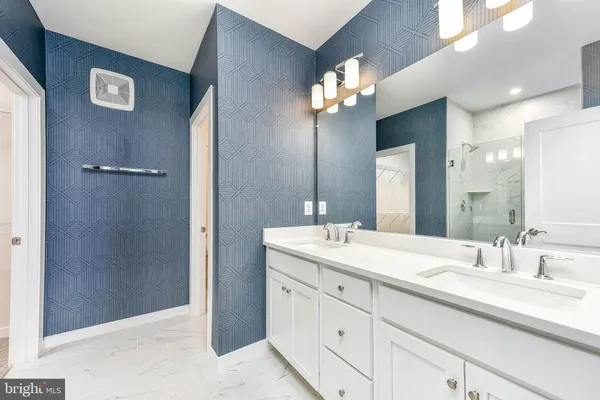 a bathroom with a double vanity sink and a mirror
