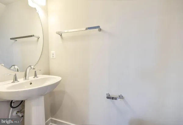 a bathroom with a sink a mirror and shower