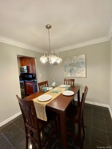a view of a dining room with furniture wooden floor and chandelier