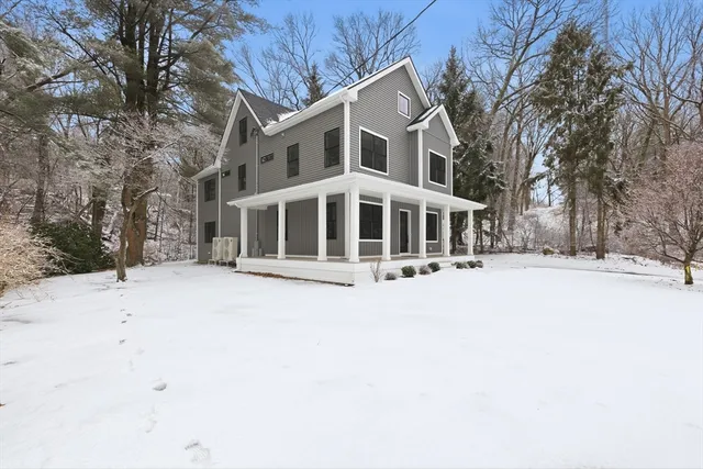 a living room with furniture flat screen tv and a large window