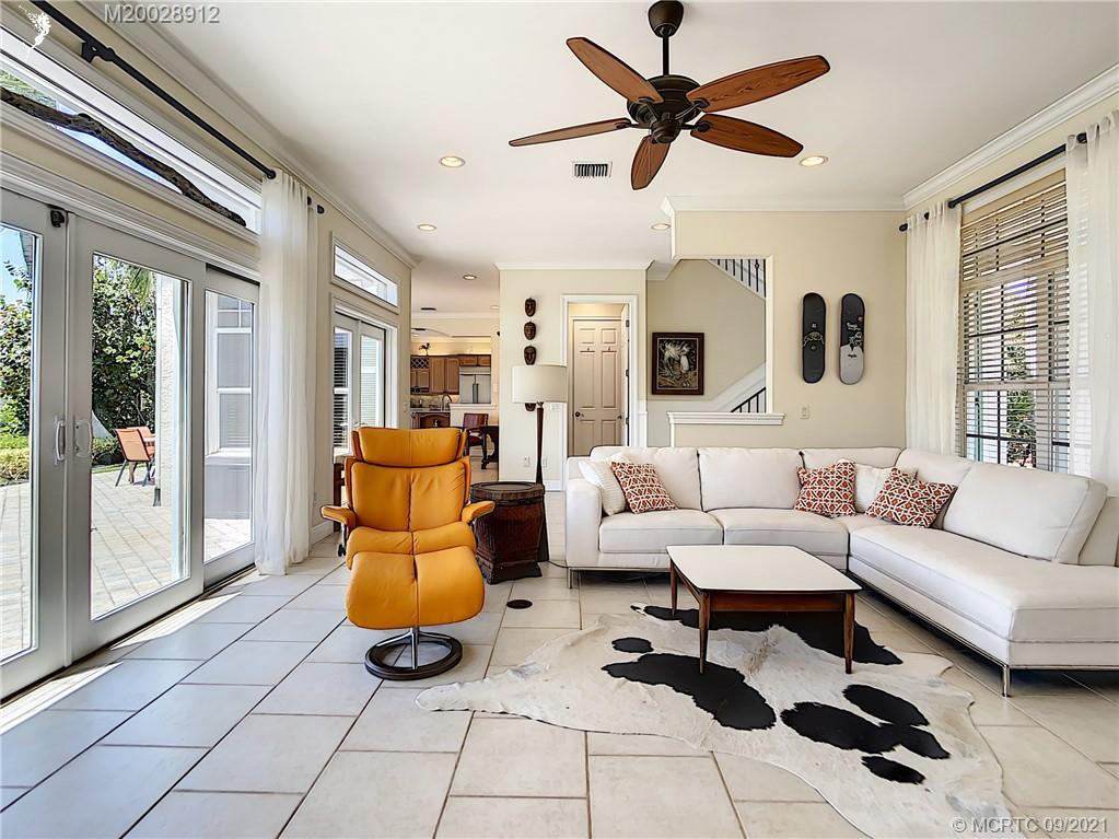 13 Simara Street Stuart, FL 34996 - Photo 13 of 37 a living room with furniture and a large window