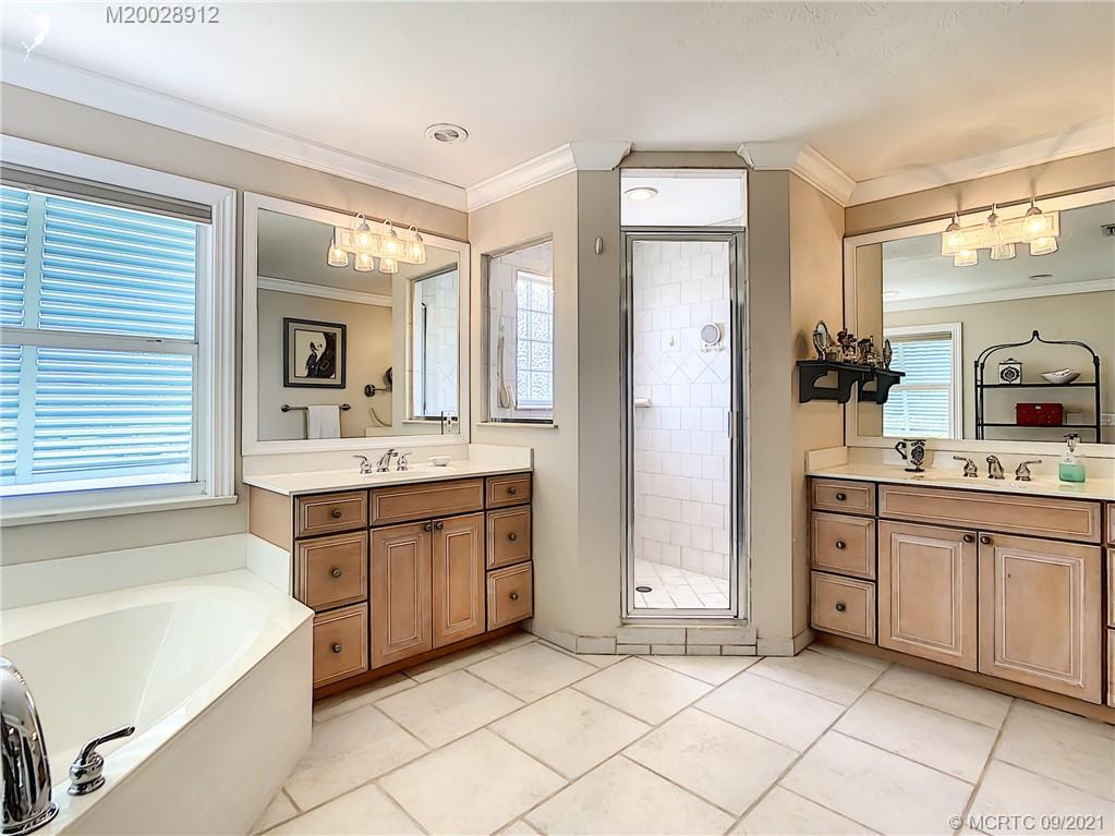13 Simara Street Stuart, FL 34996 - Photo 19 of 37 a spacious bathroom with a tub sink and mirror