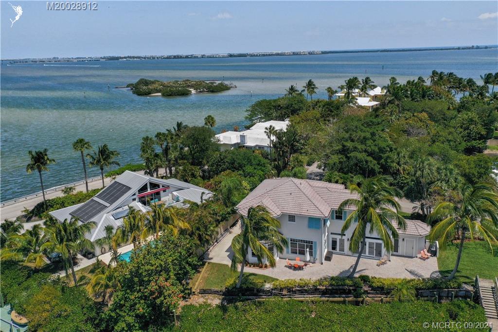 13 Simara Street Stuart, FL 34996 - Photo 2 of 37 a aerial view of a house with a garden and lake view
