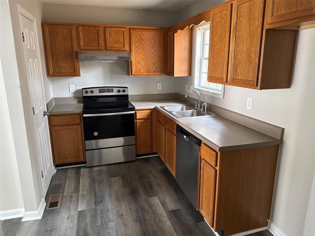 380 River Trace Drive Villa Rica, GA 30180 - Photo 9 of 12 a kitchen with a sink stove top oven and cabinets