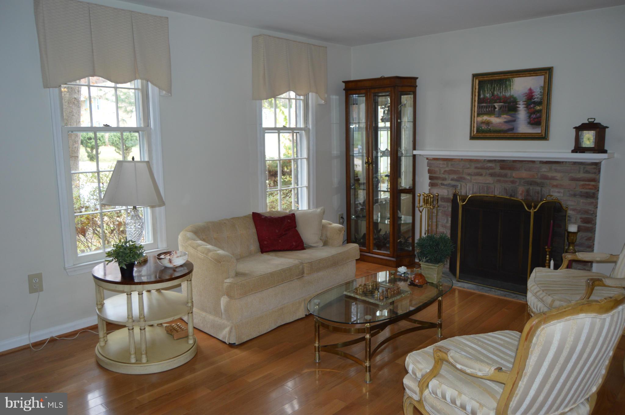2017 Hopefield Road Silver Spring, MD 20905 - Photo 8 of 30 a living room with furniture a fireplace and wooden floor