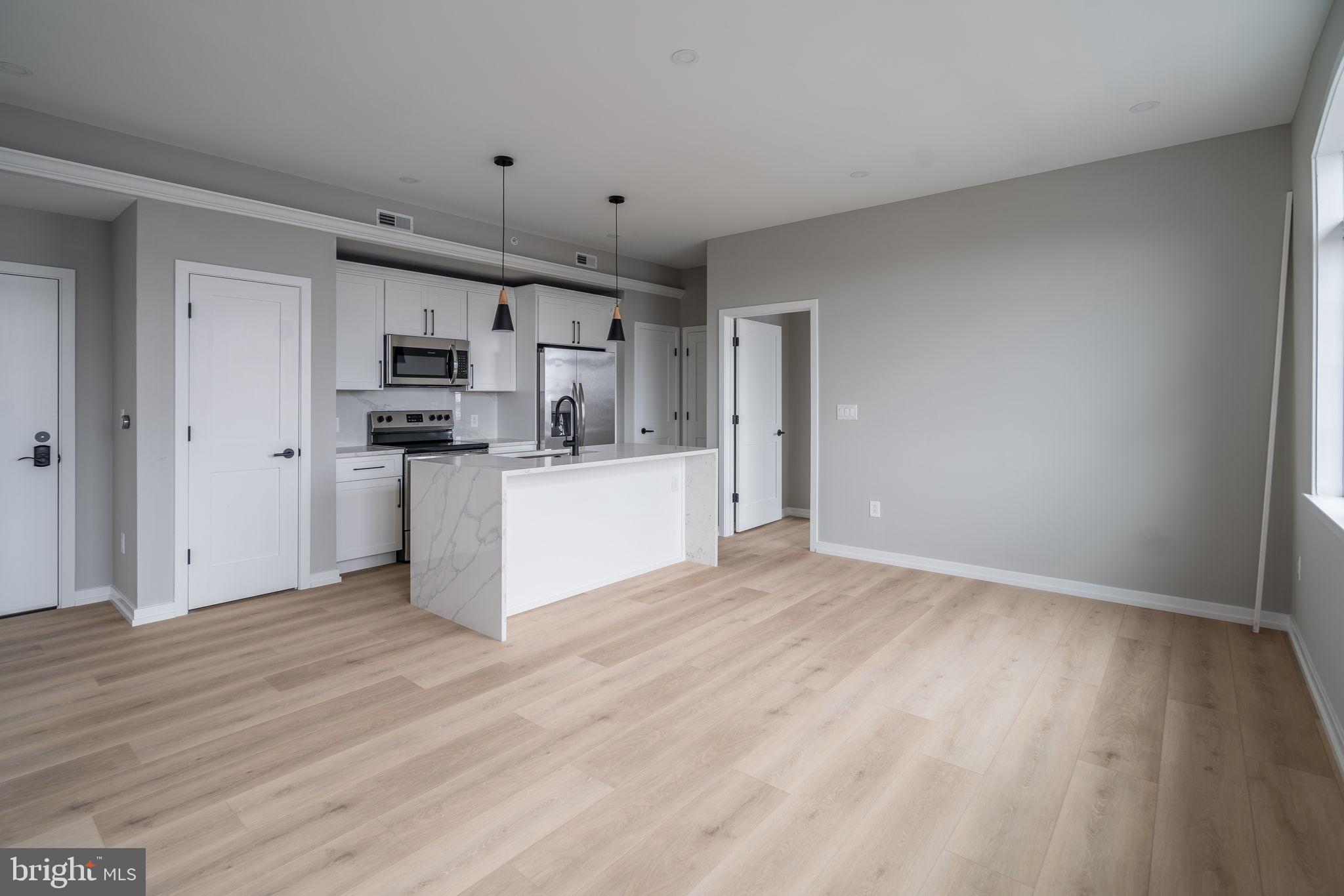 a view of kitchen and wooden floor