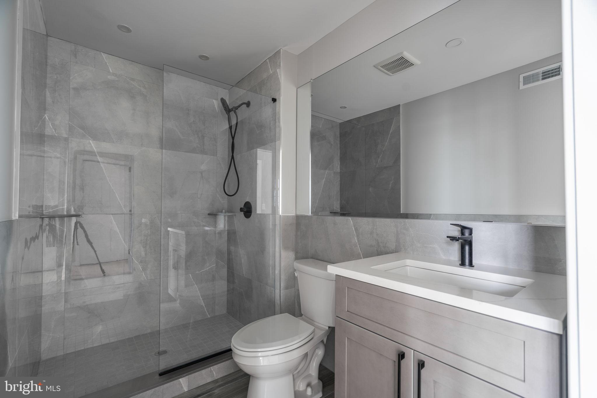 2401 Washington Avenue, Unit 5D Philadelphia, PA 19146 - Photo 11 of 18 a bathroom with a sink toilet and shower