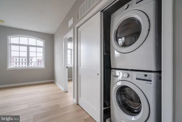 a view of a hallway with washer and dryer