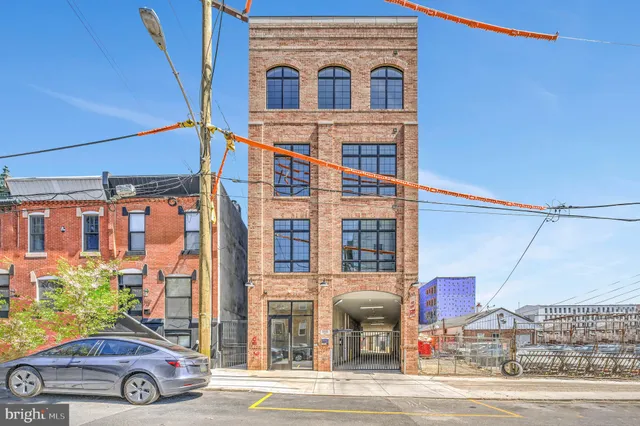 a front view of a building with parking space