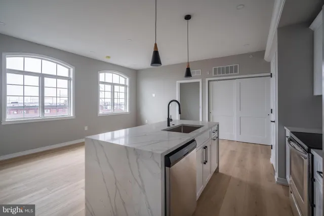 a kitchen with sink cabinets and wooden floor