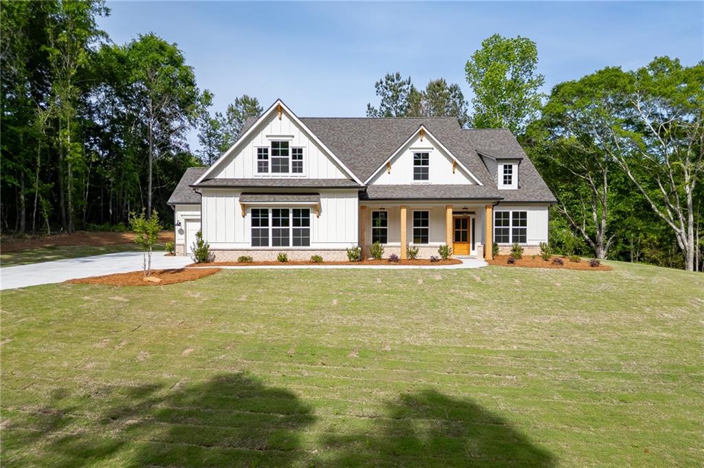1210 Austin Road Winder, GA 30680 - Photo 5 of 56 a front view of a house with a garden