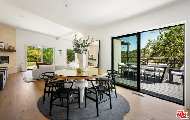 a dining room with furniture and wooden floor