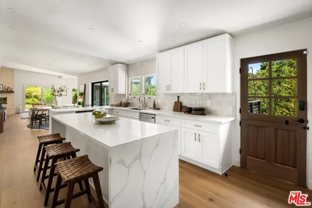 a kitchen with sink stove and cabinets