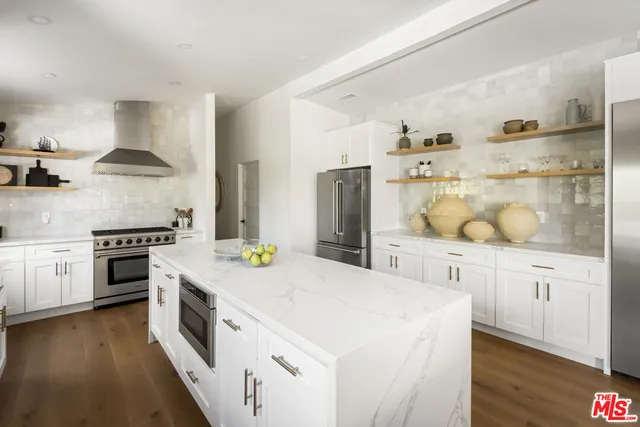 a kitchen with a stove a sink and a refrigerator